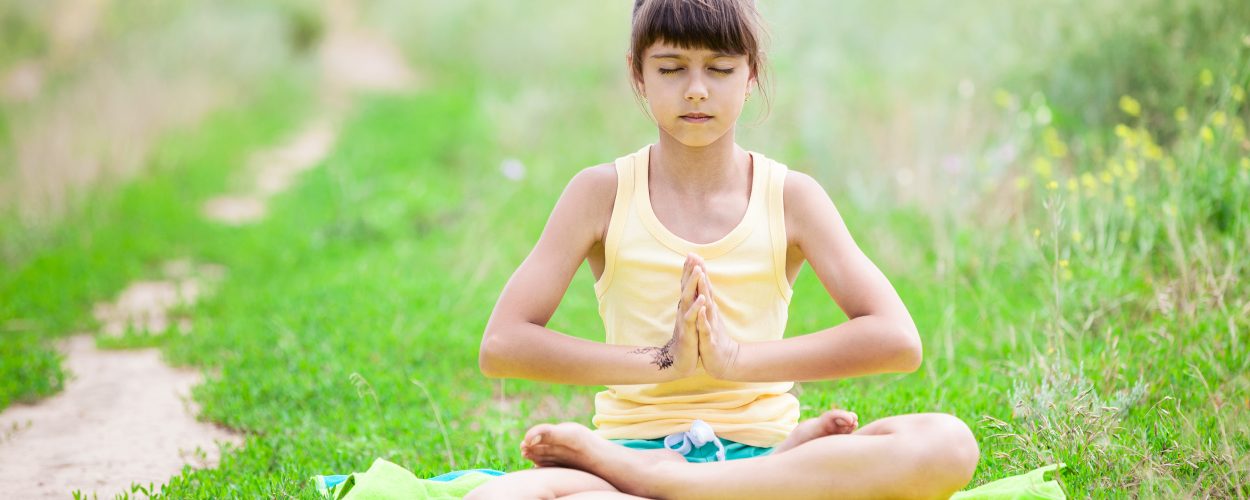 little-girl-meditating-while-sitting-in-lotus-PVG48UV